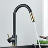 A black kitchen faucet with gold accents is shown with water flowing from it. Náhľad obrázku produktu