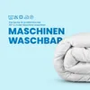 A rolled-up white duvet is shown next to text indicating it is machine washable. Produktbild-Vorschau