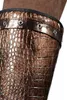 A close-up view of the top portion of a boot or leg covering with a textured, crocodile-like pattern. Produktbild-Vorschau