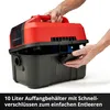 A person's hands are shown opening the lid of a red and black wet and dry vacuum cleaner. Produktbild-Vorschau