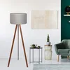A modern living room with a floor lamp, armchair, and side table.