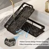 A black bathroom shelf is shown in a sink, with water running over it to demonstrate drainage. Produktbild-Vorschau