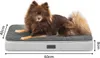 A brown dog is lying on a gray and white dog bed. Dimensions are indicated with arrows and text. Náhled obrázku produktu