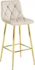 A single beige velvet bar stool with gold legs is shown against a white background. Voir les images du produit