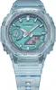 A close-up studio shot of a transparent blue Casio G-Shock watch with a teal face. Produktbild-Vorschau