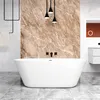 A modern bathroom with a freestanding oval bathtub, marble-patterned wall, and pendant lights. Produktbild-Vorschau