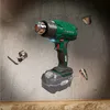 A cordless heat gun with accessories floating around it against a textured background. Produktbild-Vorschau