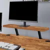 A monitor stand on a wooden desk. Voir les images du produit
