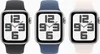 Three Apple Watches are displayed side-by-side against a white background. Each watch has a different colored band: black, blue, and white. The watch faces show a stylized clock with large numbers. Náhled obrázku produktu