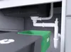 Under-sink plumbing and waste bins. Produktbild-Vorschau
