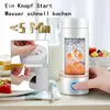 A person's hand is pressing a button on a portable electric kettle, which is shown with water heating inside. In the background, there are breakfast items like toast and fruit. Produktbild-Vorschau