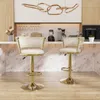 Two white and gold bar stools are shown in a modern kitchen setting. Voir les images du produit