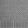 A close-up view of a textured gray carpet with a ribbed, arched pattern. Voir les images du produit