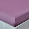 A close-up view of a purple fitted sheet on a bed. Produktbild-Vorschau