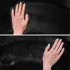 Two close-up shots of a hand touching a black carpet. Podgląd zdjęcia produktu