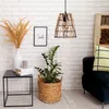 A cozy living room corner with a hanging lamp, side table, and plant. Náhled obrázku produktu