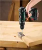 A hand holding a cordless drill is drilling a screw into a metal bracket attached to a wooden surface. Produktbild-Vorschau