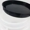 A close-up view of a black lid resting on the rim of a white container. Produktbild-Vorschau