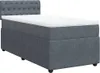 A dark gray box spring bed with a white mattress and a tufted headboard, shown from a side angle on a white background. Produktbild-Vorschau