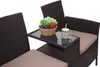 A close-up view of a poly-rattan bench with a small table attached, featuring a bowl of fruit and a drink. Náhled obrázku produktu