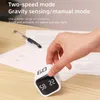 A hand is holding a white cube timer on a wooden desk with papers and a pen in the background. Produktbild-Vorschau