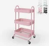 A pink three-tier metal serving cart with wheels is shown against a white background. In the upper right corner, there are smaller images of the same cart in different colors (white, mint green, pink, black). Produktbild-Vorschau
