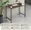 A desk with a laptop, mug, and plant. Náhled obrázku produktu