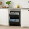 A black multi-compartment trash can with two flip-down doors, situated under a kitchen counter between two white cabinets. The trash can contains four bins, two at the top and two at the bottom, with blue liners in the bottom bins. Produktbild-Vorschau