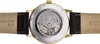 The back of a watch with a visible movement and leather strap. Náhled obrázku produktu