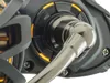 A close-up view of a fishing reel's handle and drag adjustment mechanism. Anteprima dell’immagine prodotto
