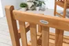 Close-up of a wooden garden chair with a brand logo. Produktbild-Vorschau