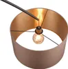 A close-up view of a modern floor lamp with a black metal arm and a drum-shaped lampshade with a gold interior. Produktbild-Vorschau