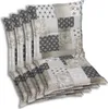 A stack of four chair cushions with a patchwork design. Produktbild-Vorschau