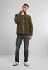 A man wearing a green fleece jacket and gray jeans stands against a light gray background. Produktbild-Vorschau