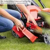 A person is shown attaching a red accessory to a lawnmower. Produktbild-Vorschau