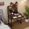 A vanity desk with a mirror and lights, set up in a bedroom next to a bed and a plant. Podgląd zdjęcia produktu