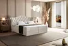 A luxurious bedroom with a large bed, nightstands, and decorative elements. Produktbild-Vorschau