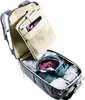 An open backpack with clothes and a tablet inside. Produktbild-Vorschau