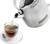 Water being poured from a kettle into a glass cup of tea. Produktbild-Vorschau