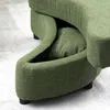 A close-up view of a green sofa with a hidden storage compartment. Produktbild-Vorschau