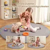 A young girl is playing with a toy robot dog on a round rug, with inset images showing different play scenarios. Produktbild-Vorschau