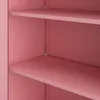 Close-up view of the interior of a pink metal cabinet with shelves. Podgląd zdjęcia produktu