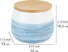 A ceramic storage jar with a bamboo lid, featuring a blue watercolor-like pattern on the lower half and white on the upper half. Dimensions are indicated with measurement lines and text. Produktbild-Vorschau