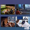 Collage of four images showing a projector being used in different scenarios: outdoor movie night, gaming, indoor movie watching, and a business presentation. Náhled obrázku produktu