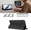 A person is using a phone with a case that is propped up as a stand, next to a laptop. Produktbild-Vorschau