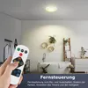 A bathroom with a ceiling light and a remote control in the foreground. Produktbild-Vorschau