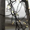 A close-up shot of a string of warm white LED lights wrapped around a wooden post. Podgląd zdjęcia produktu