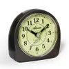 A close-up studio shot of an analog alarm clock. Produktbild-Vorschau
