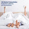 Two people in bed, covered by white duvets, with their feet visible, holding white mugs. Produktbild-Vorschau