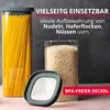 Two glass storage containers filled with spaghetti and rice, with a lid in the foreground. Produktbild-Vorschau